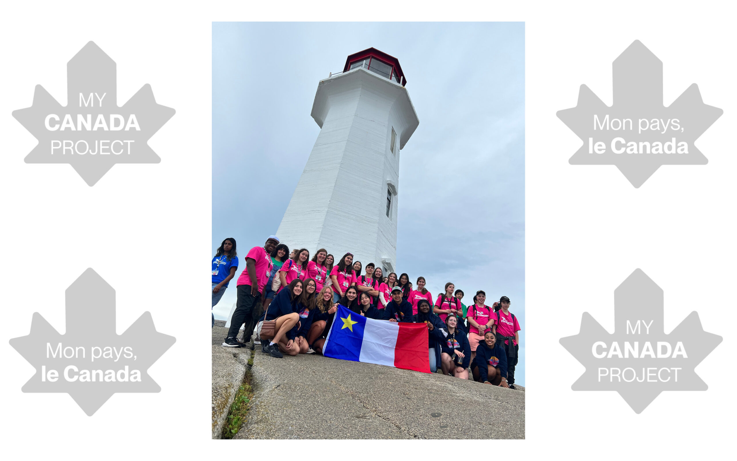 A group photo of about 30 young people participating in the SHAD and FNJA trip to Halifax. They are standing in front of the lighthouse at Peggy’s Cove, NS, and are holding the Acadian flag. The trip was facilitated by French for the Future (https://french-future.org/).